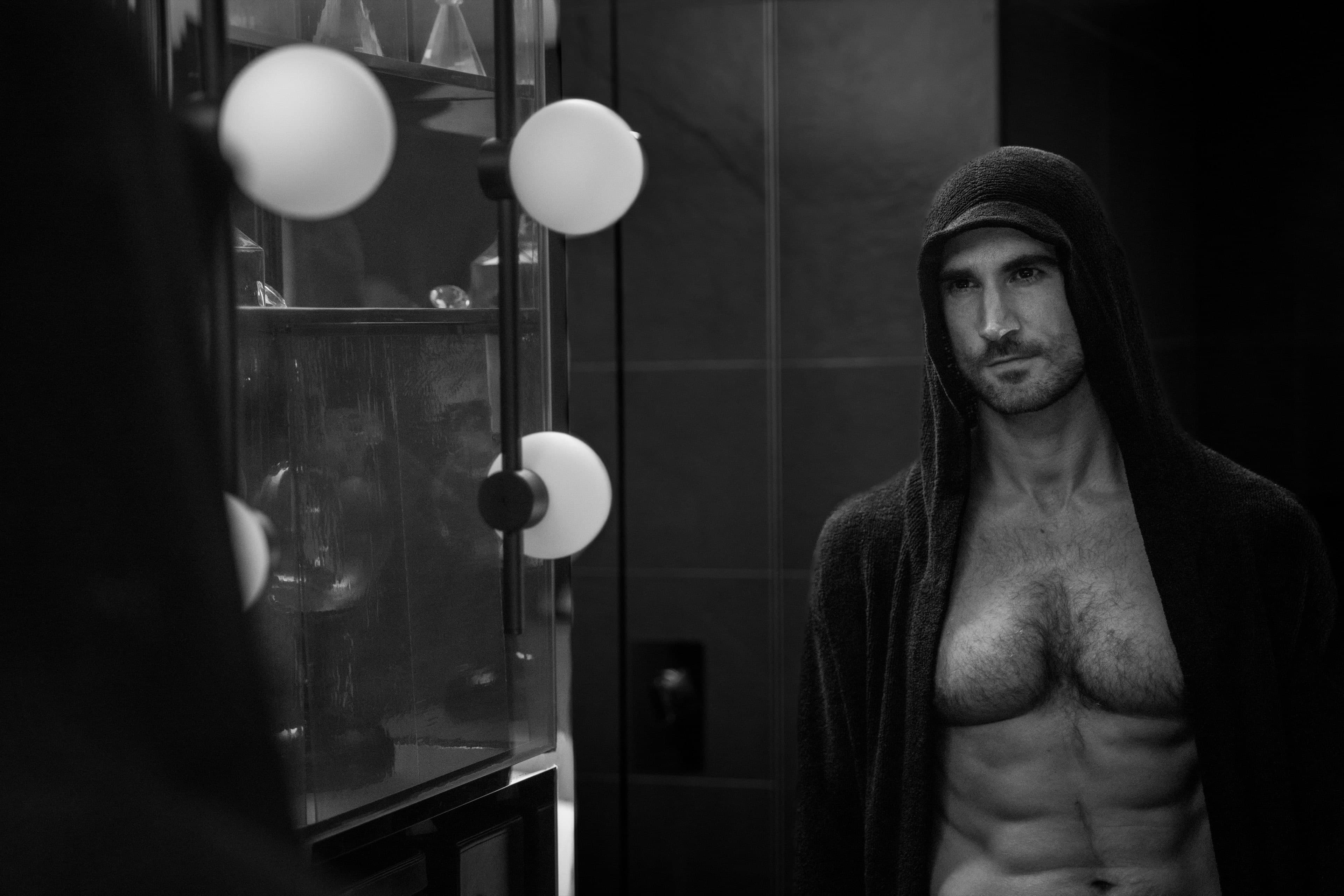 Atmospheric editorial portrait of a verified member, backstage